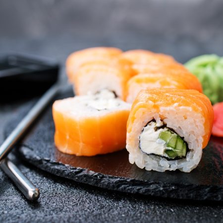 Sushi with chopsticks. Sushi roll japanese food on a table