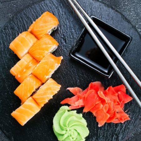 Sushi with chopsticks. Sushi roll japanese food on a table